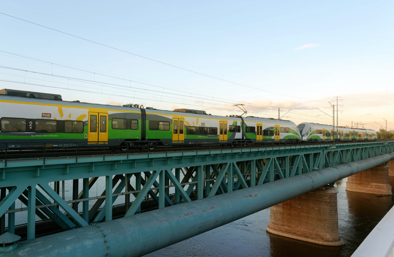 25 - Koleje Mazowieckie Stadler FLIRT electric train traveling across the Citadel Rail Bridge in Warsaw, Poland